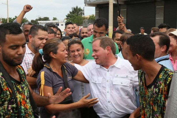 Juan Pablo Guanipa, candidate of the MUD for the Zulia state governor office, greets supporters after casting his vote during a nationwide election for new governors in Maracaibo